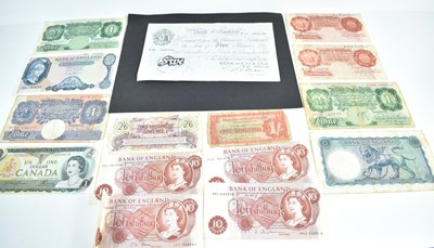 Lot 299 - A collection of banknotes to include a white...