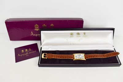 Lot 302 - A Garrard gold cased wrist watch, of curved...