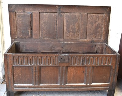 Lot 558 - A 17th century oak coffer, with four panel lid,...