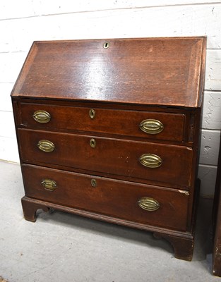 Lot 553 - An early 19th century oak bureau, with fall...