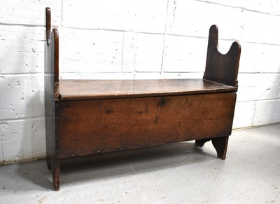 Lot 555 - A 17th century oak coffer / settle, the...