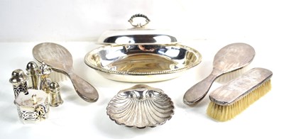 Lot 251 - A group of silver to include salt and pepper...