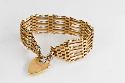 Lot 63 - A 9ct gold gate link bracelet, with heart...