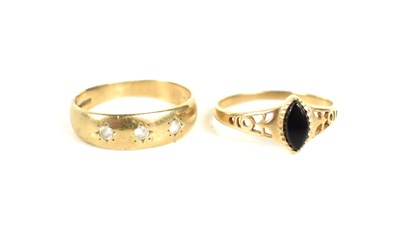 Lot 195 - Two 9ct gold rings, a planished band set with...