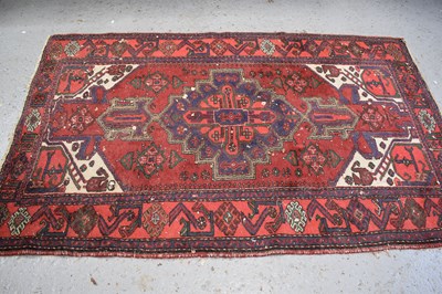 Lot 502 - A Middle Eastern red ground wool rug, with...