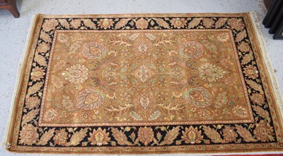 Lot 508 - A Mughal wool rug, with ochre ground, black...