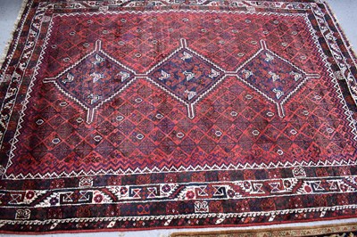 Lot 515 - A large Iranian red ground Tribal wool rug,...