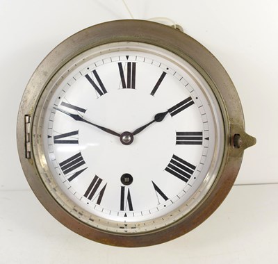 Lot 363 - A naval metal bulk head ships clock, with...