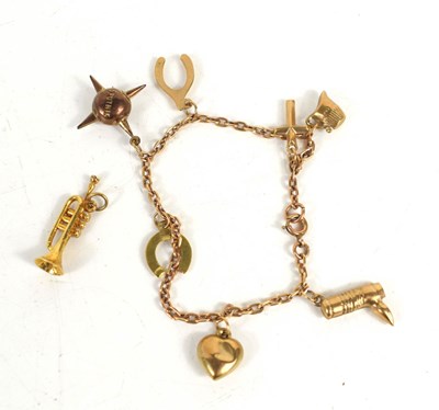 Lot 223 - A 9ct gold charm bracelet with seven charm...