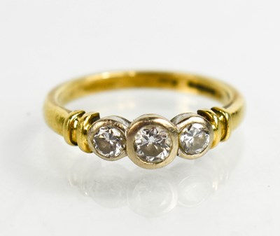 Lot 4 - An 18ct gold and diamond ring, the three...