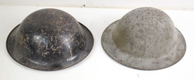 Lot 117 - Two steel Brodie helmets, one having the...