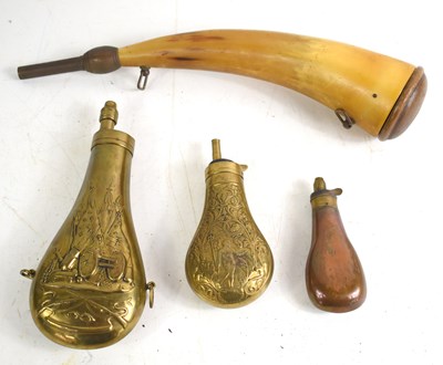 Lot 116 - A group of powder flasks to include a brass...