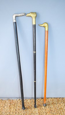 Lot 545 - A group of three walking canes, with brass...