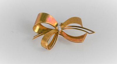 Lot 206 - A 14ct gold bow brooch, inset with diamonds to...