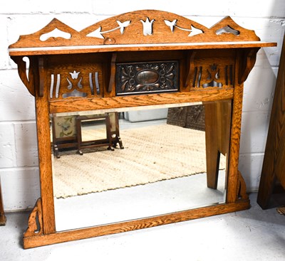 Lot 573 - An Arts & Crafts period oak overmantle mirror...