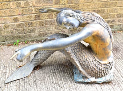 Lot 387 - A bronzed metal mermaid, 55 by 80cm.