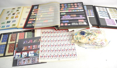 Lot 404 - A collection of stamps, loose and in three...