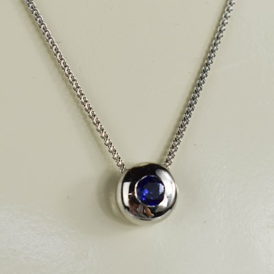 Lot 30 - A 9ct white gold and sapphire pendant and...