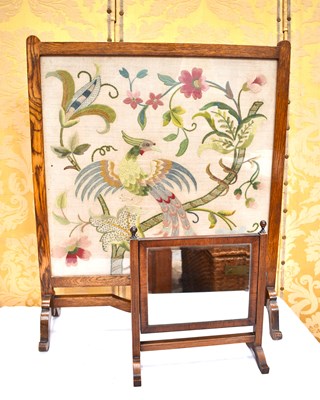Lot 564 - A 20th century oak fire screen with...