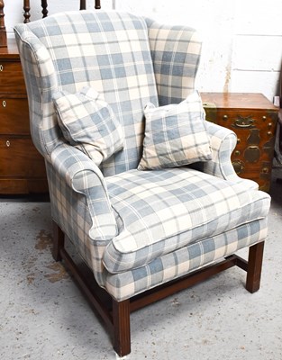 Lot 574 - A 20th century wingback armchair, in blue and...
