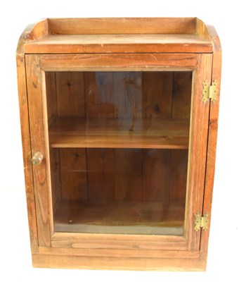 Lot 556 - An antique pine glazed display cabinet with...