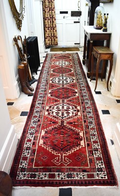 Lot 420 - A vintage Karadja woolen runner, red ground...