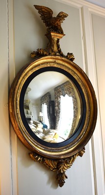 Lot 366 - A large giltwood Regency convex mirror, with...