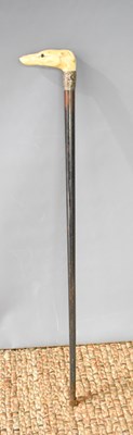 Lot 243 - A 19th century ebonised walking cane with...