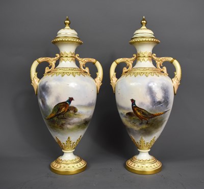 Lot 28 - A pair of Royal Worcester twin handled vases...
