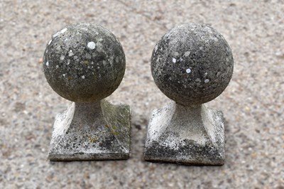Lot 514 - A pair of 20th century stone pillars with ball...