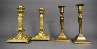 Lot 395 - Two pairs of 19th century brass candlesticks,...