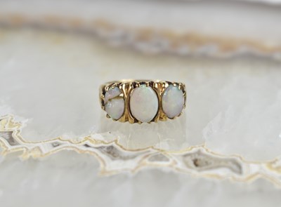 Lot 134 - A 9ct gold and opal three stone ring, 2.6g.