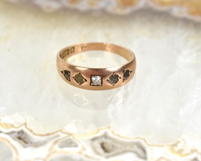 Lot 43 - A 9ct gold and diamond ring, four stones...