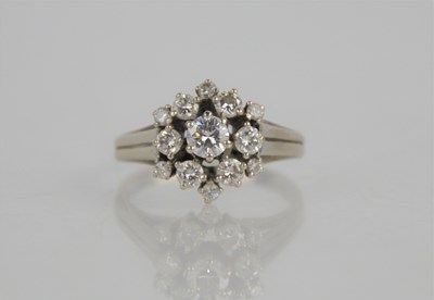 Lot 33 - A 14ct white gold and diamond dress ring of...