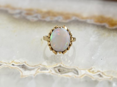 Lot 128 - A 9ct gold and opal solitaire ring, size H, 2.7g.
