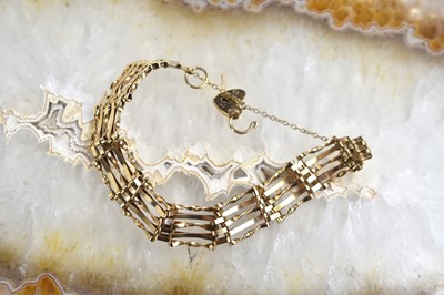 Lot 181 - A 9ct gold gate link bracelet with safety...