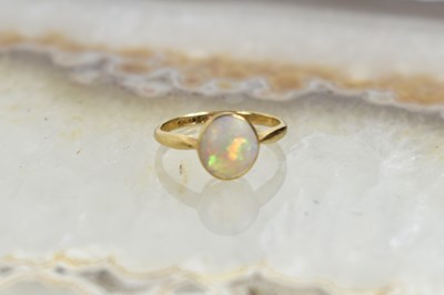 Lot 107 - An 18ct gold and opal ring of oval form, size...