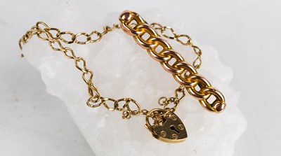 Lot 374 - A 9ct gold chain link bracelet with heart...