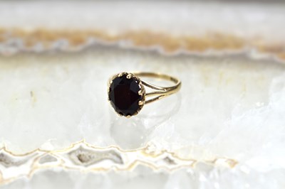 Lot 53 - A 9ct gold and garnet set ring, size L, 1.9g.