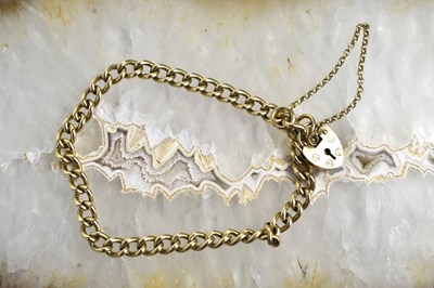 Lot 135 - A 9ct gold charm bracelet with heart form...