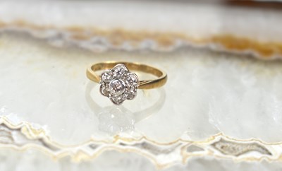 Lot 60 - An 9ct gold and seven diamond flowerhead...