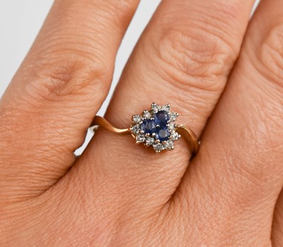 Lot 380 - A 9ct gold, diamond and sapphire ring, the...