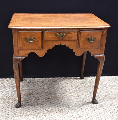 Lot 459 - A George II oak lowboy on cabriole legs...