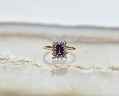 Lot 61 - A 9ct gold, diamond and amethyst cluster ring,...