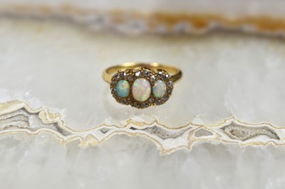 Lot 185 - An 18ct gold, diamond and three stone opal...