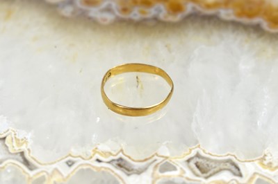 Lot 58 - A 22ct gold wedding band, size L/K, 1.3g.