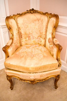 Lot 450 - A 19th century French wingback armchair,...