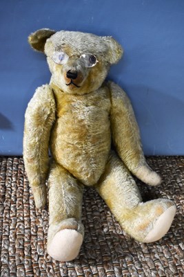 Lot 224 - A golden plush vintage teddy bear with humped...