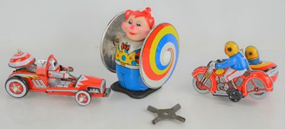 Lot 54 - A group of three vintage tinplate toys,...