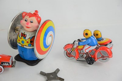 Lot 54 - A group of three vintage tinplate toys,...